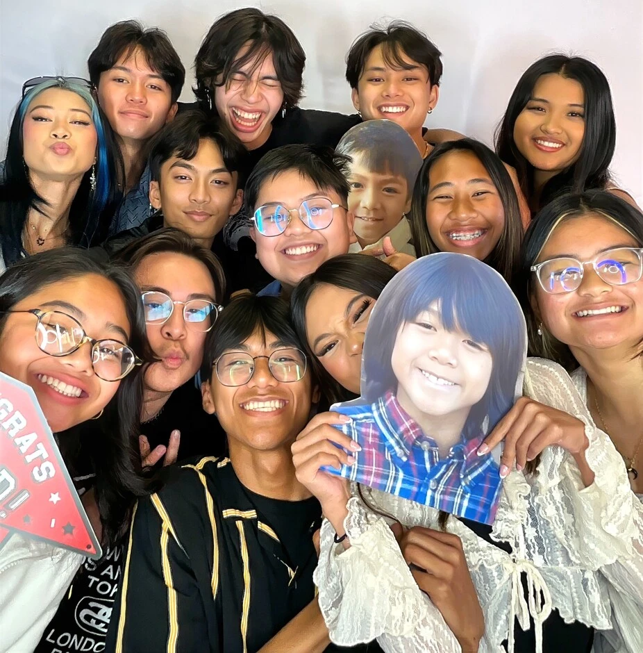 A group of guests poses at a graduation celebration.