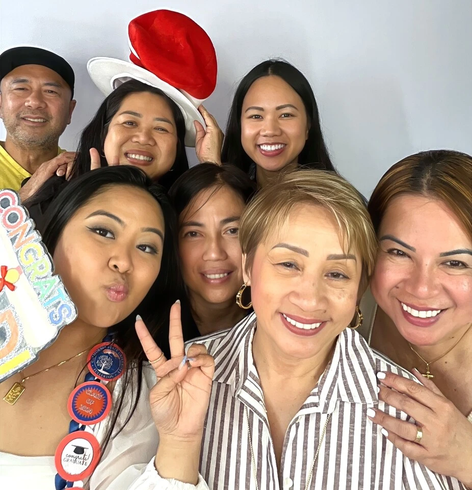 A group of guests poses at a graduation celebration.