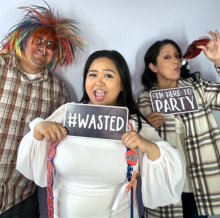 Party guests pose at a graduation celebration.