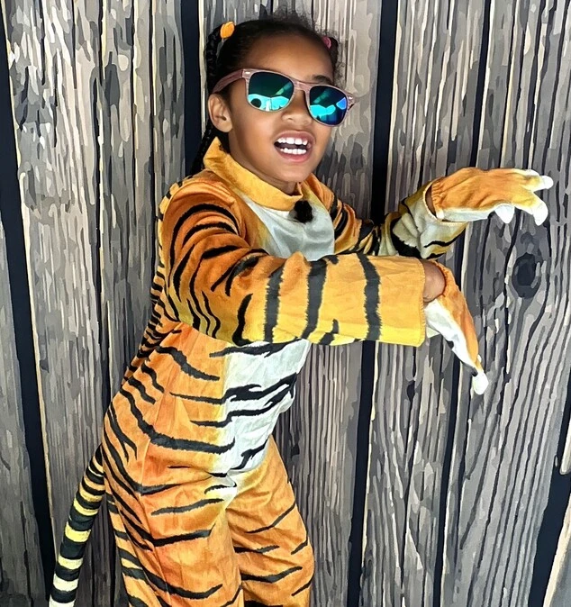 Children pose at a Halloween costume party.