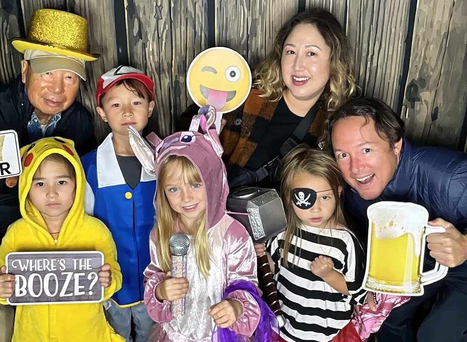 A family poses at a Halloween costume party.