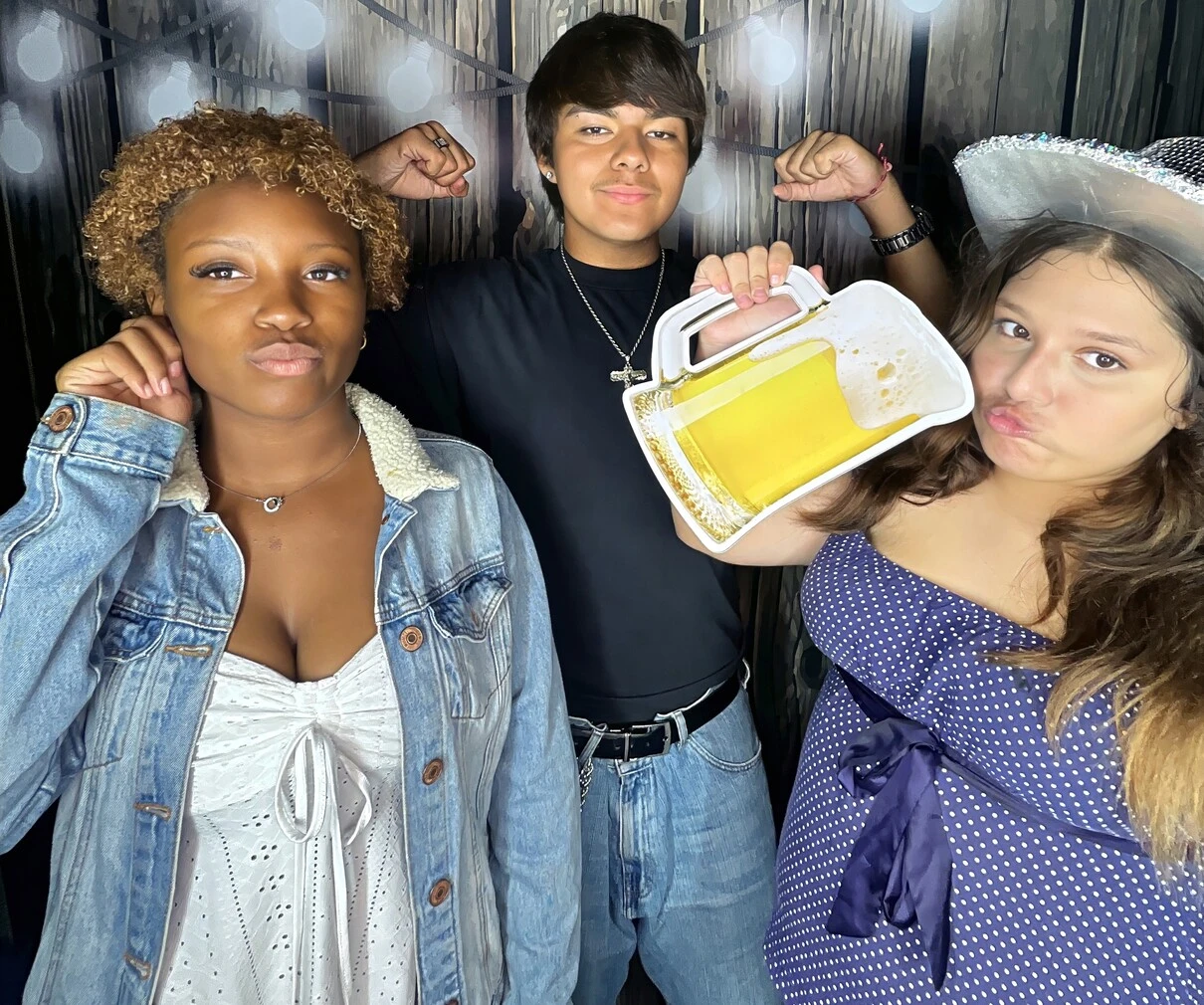 Friends pose with playful photo booth props at a Los Angeles celebration.