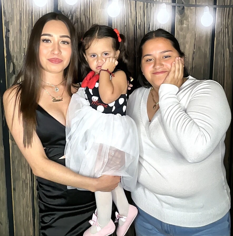 Party guests pose at a quinceañera celebration.