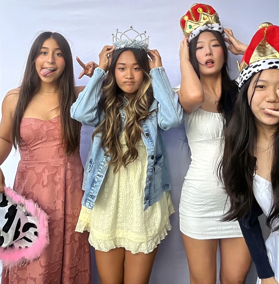 Teen friends pose at a birthday party.