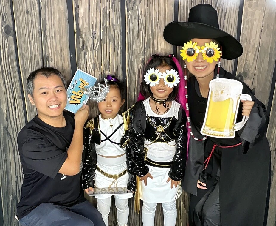 Friends pose in party costumes at a Halloween costume party.