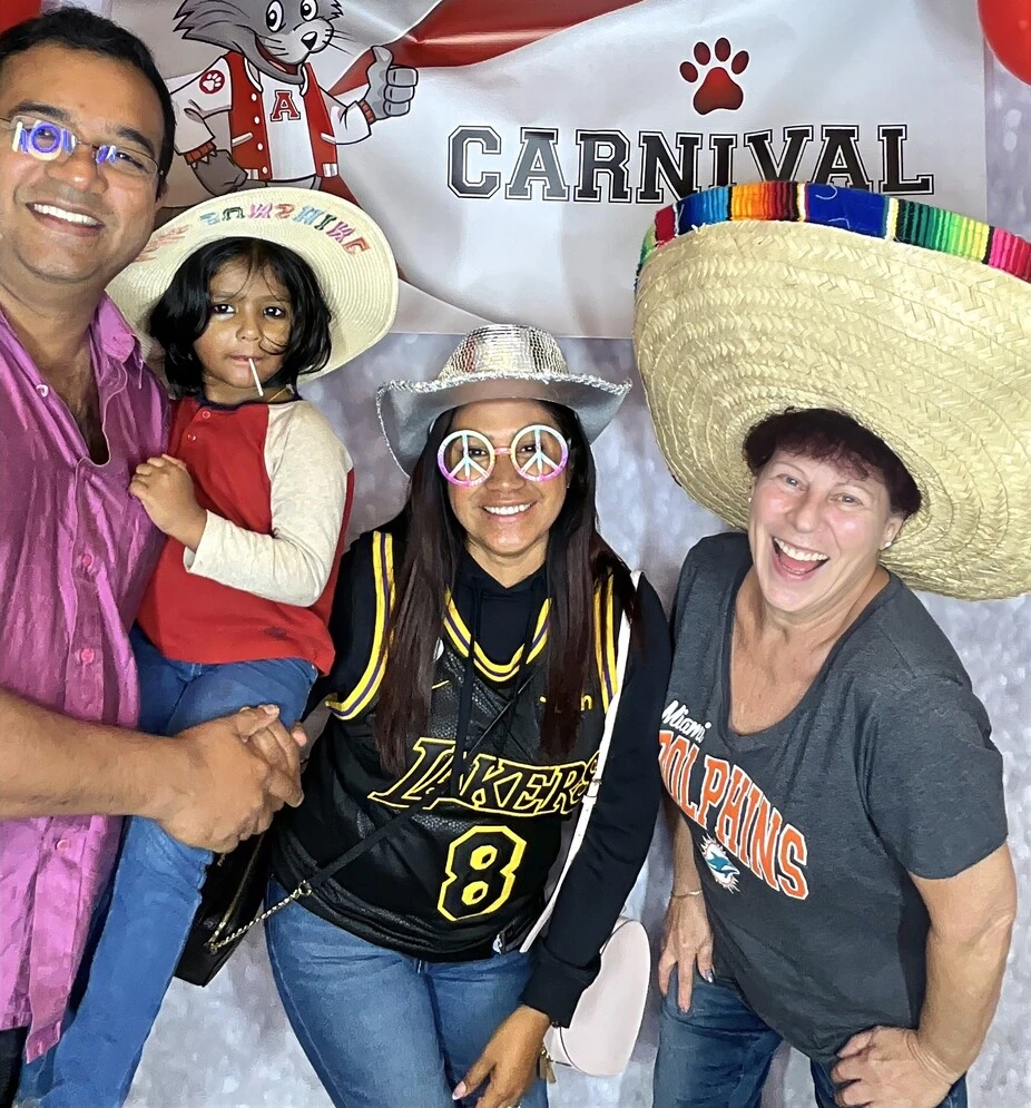 Guests pose with sombrero props at a fiesta-themed celebration.