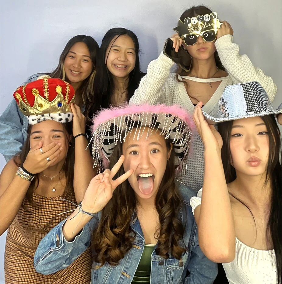 Friends pose at a birthday party.