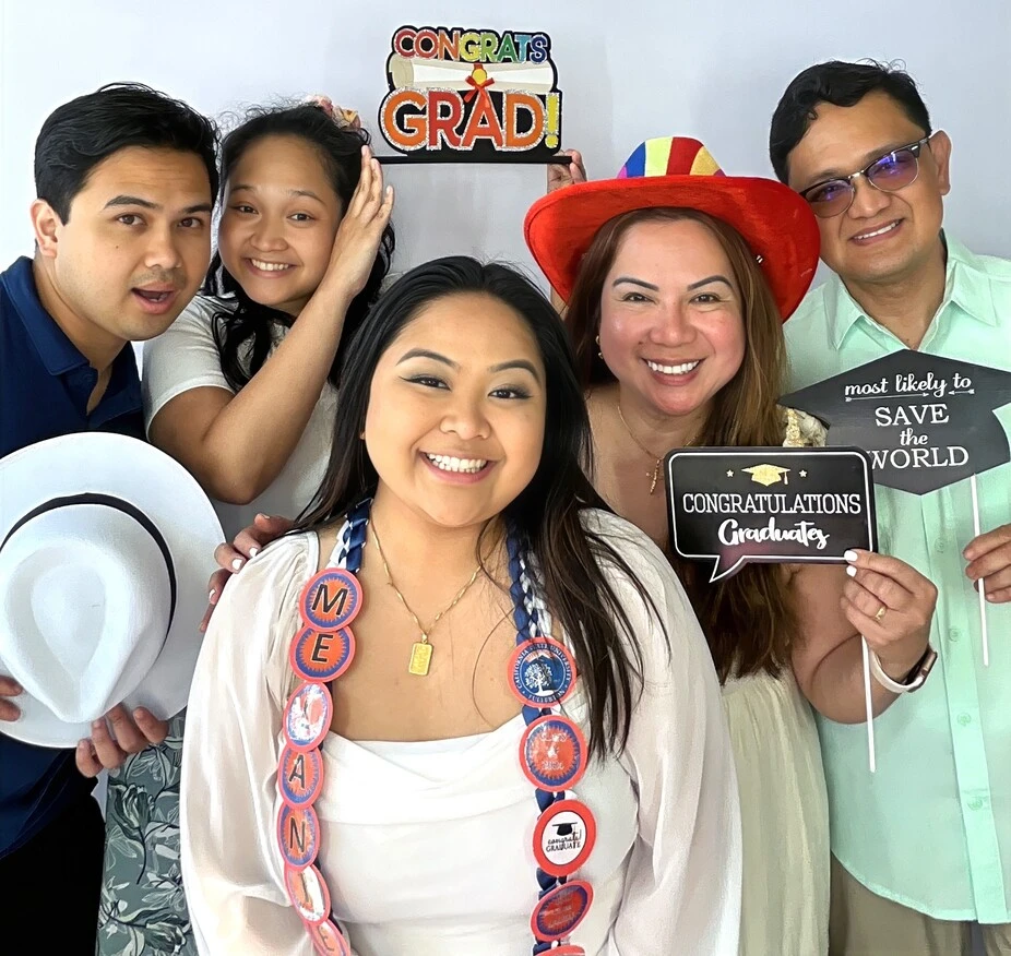 A family poses at a graduation celebration.