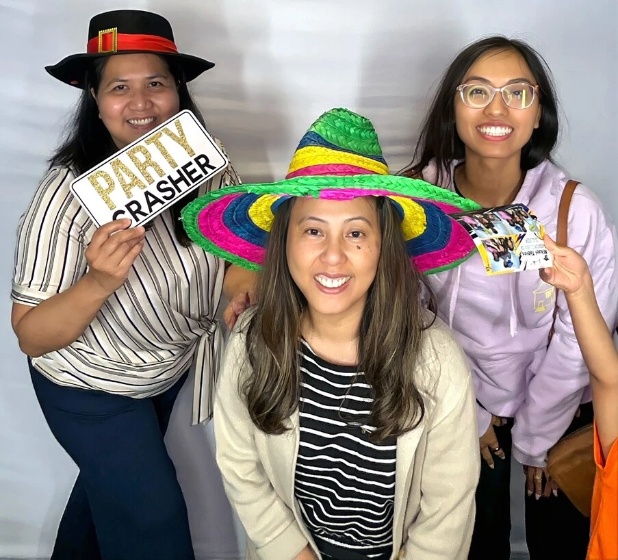 Party guests pose at a graduation celebration.
