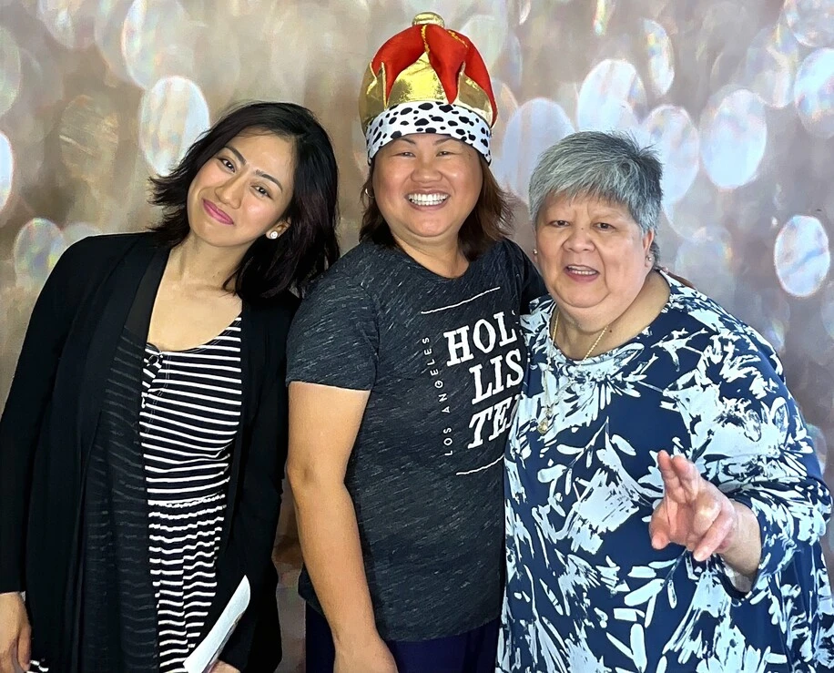 Guests pose with playful photo booth props at a graduation celebration.