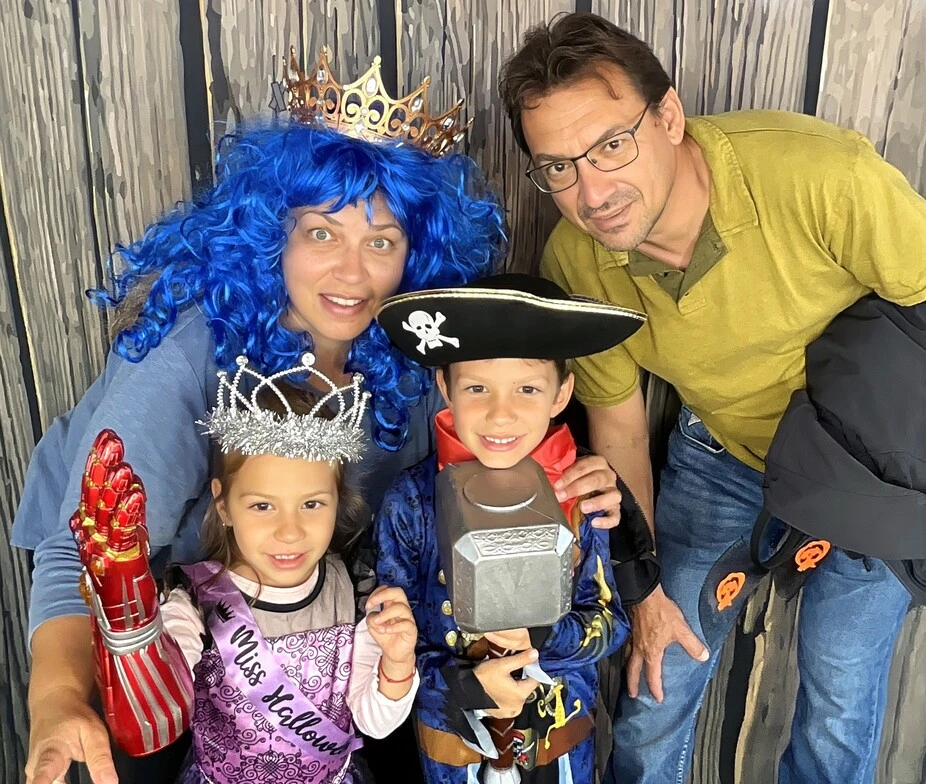 A family poses at a Halloween costume party.