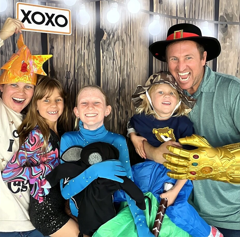 Guests pose in party costumes at a Halloween costume party.