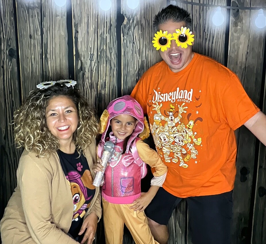 Guests pose in party costumes at a Halloween costume party.