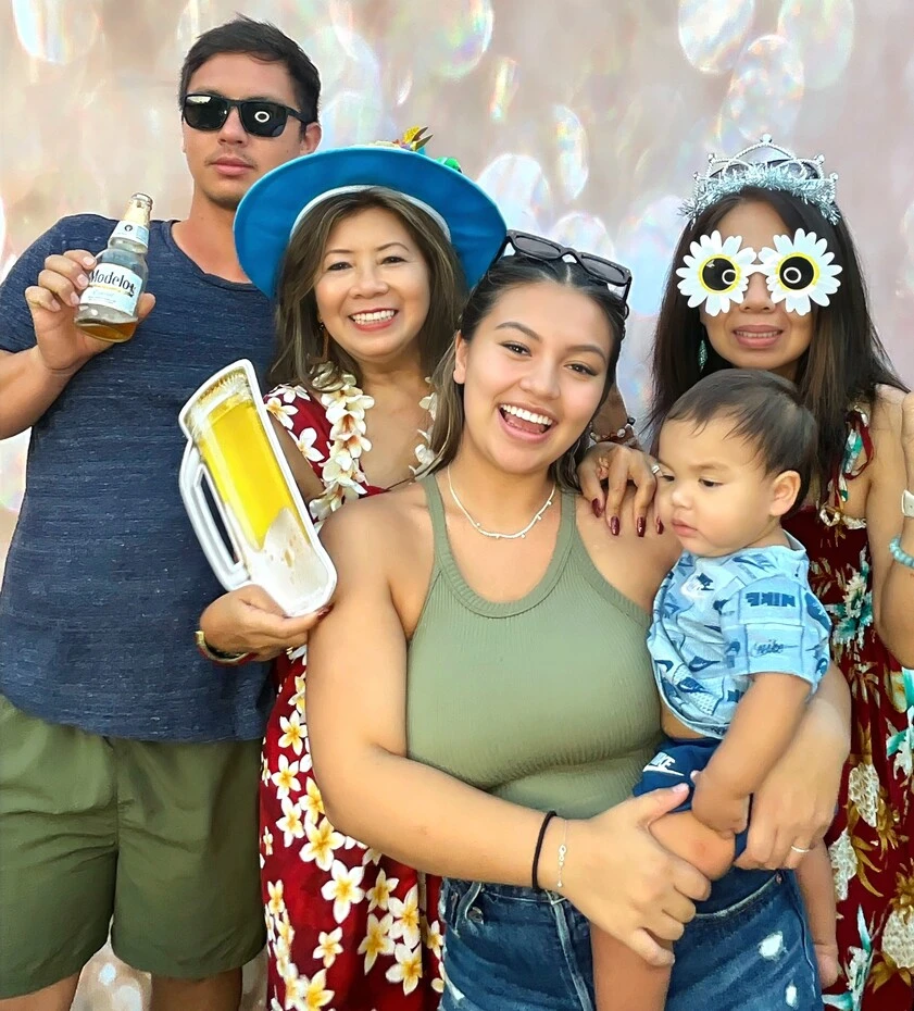 A group of guests poses at a tropical-themed party.
