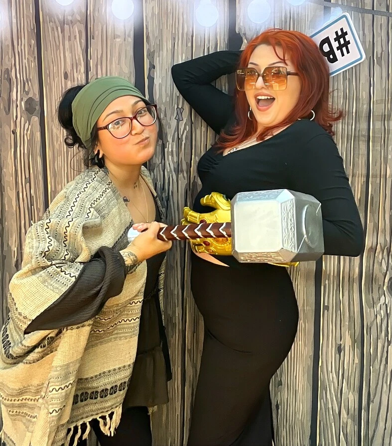 Guests pose in party costumes at a Halloween costume party.