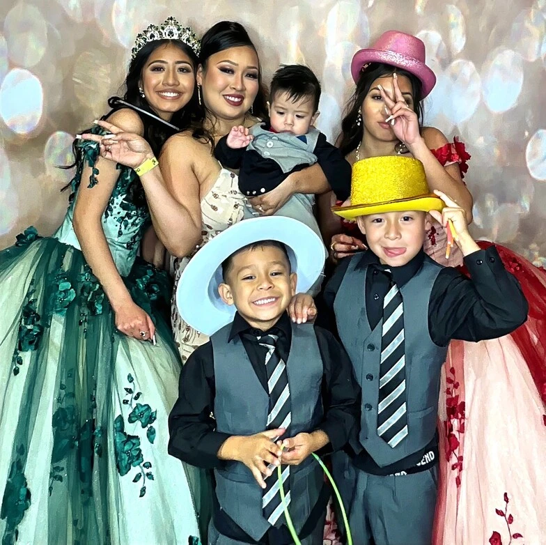 A family poses at a quinceañera celebration.