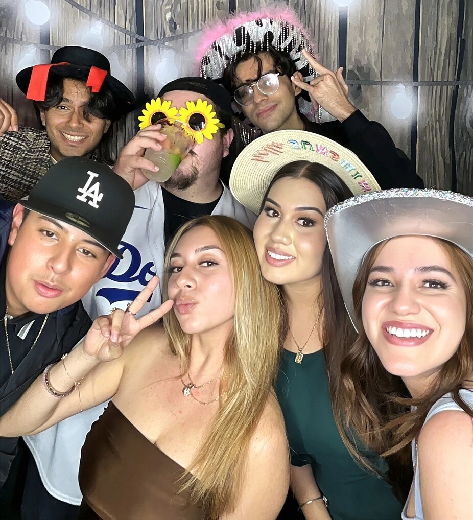 Party guests pose at a quinceañera celebration.
