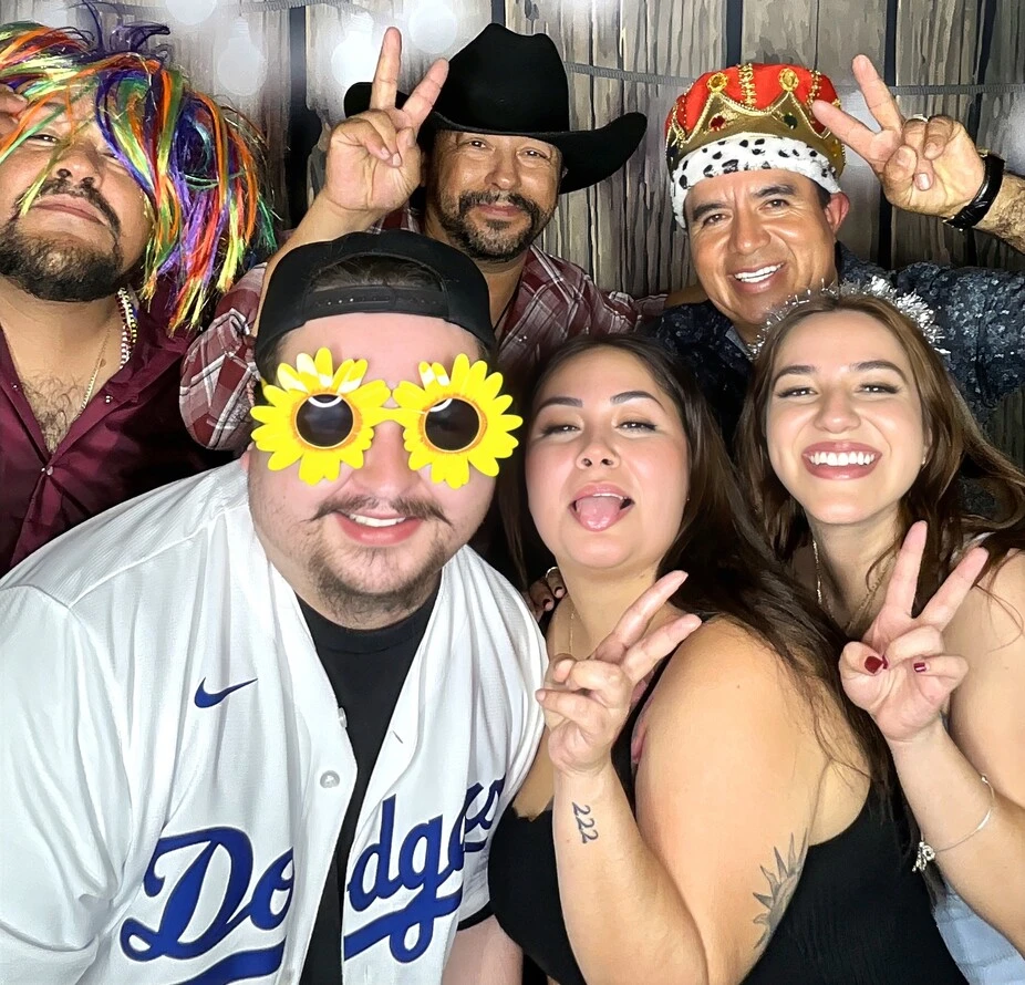Party guests pose at a quinceañera celebration.