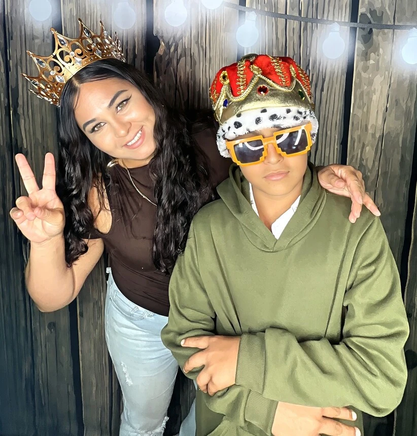 Guests pose with playful photo booth props at a Los Angeles celebration.