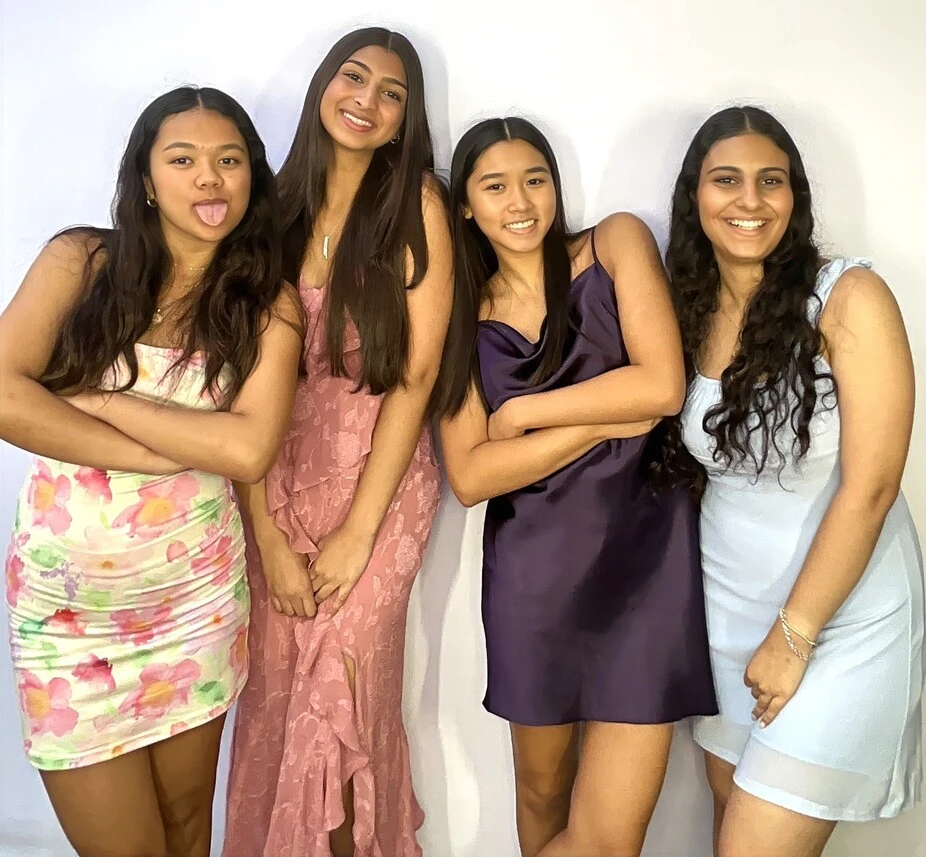 A group of guests poses at a Sweet 16 celebration.