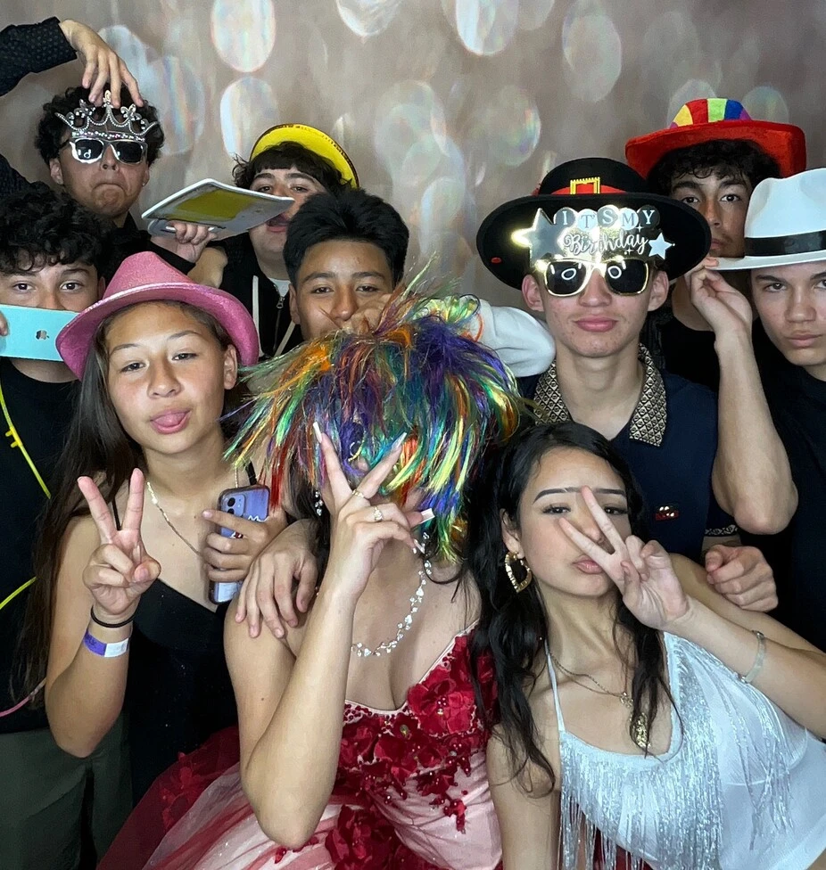 Teen friends pose at a birthday party.