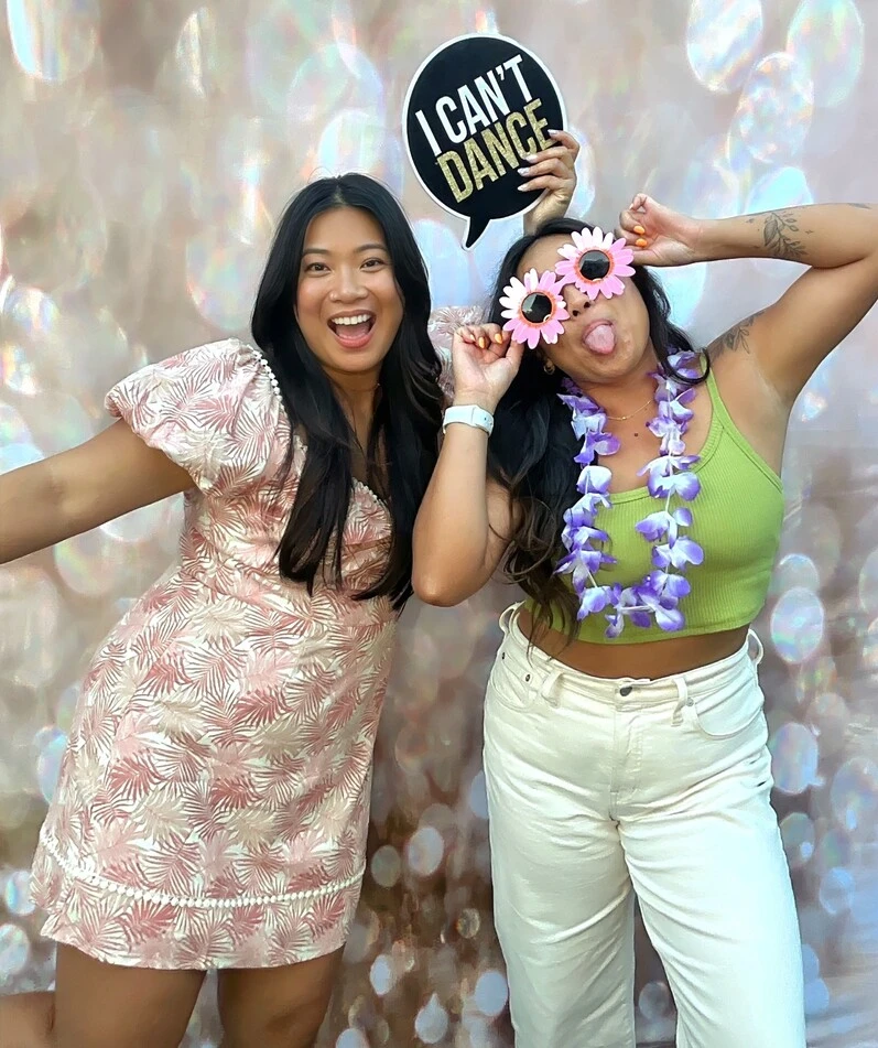 Party guests pose at a tropical-themed party.