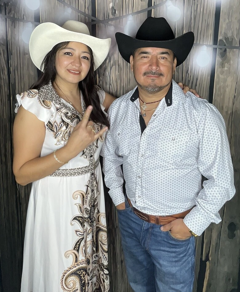 A group of guests poses at a western-themed party.