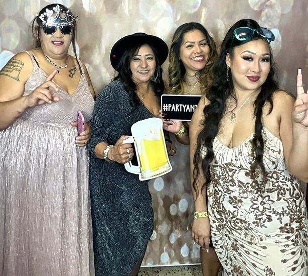 Friends pose at a birthday party.