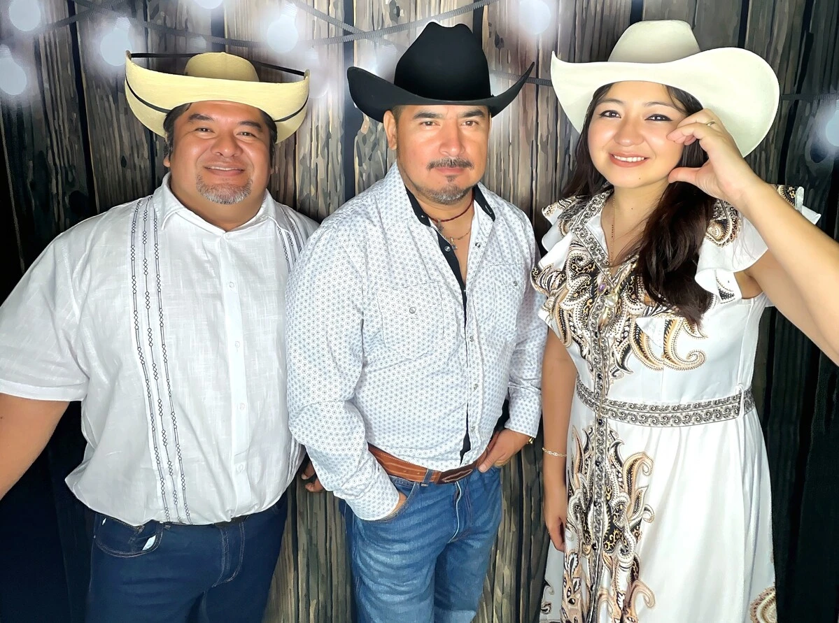 A family poses at a western-themed party.
