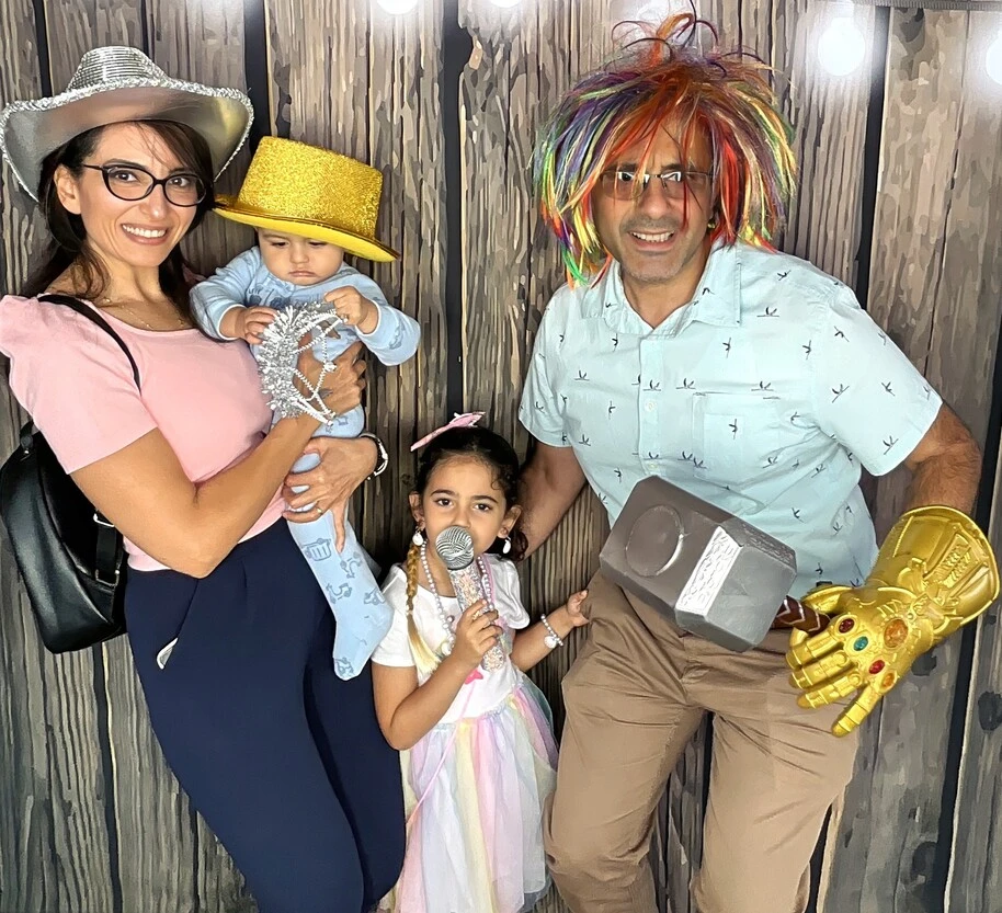 A family poses at a Halloween costume party.