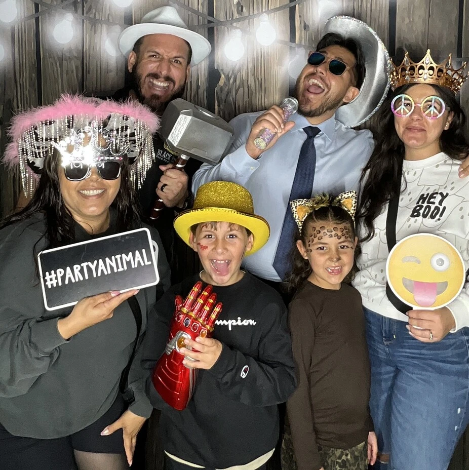 Party guests pose at a Halloween costume party.