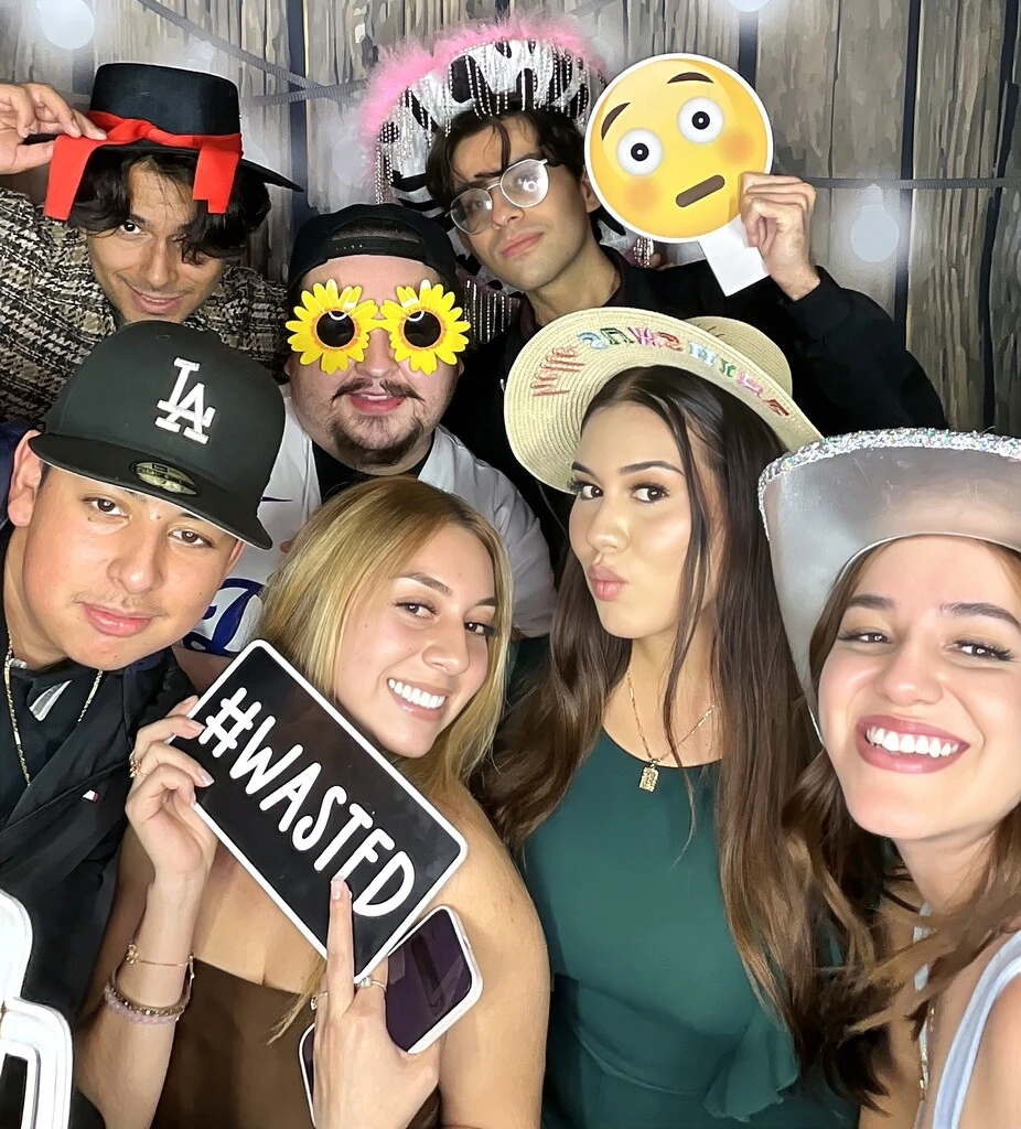 A group of guests poses at a quinceañera celebration.