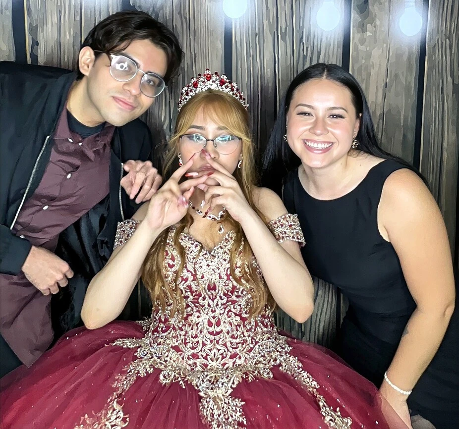 A quinceañera court poses at a quinceañera celebration.