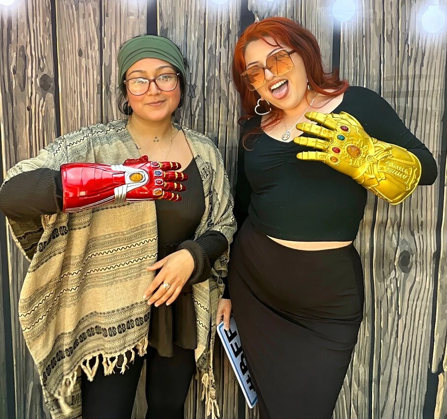 Friends pose with superhero props at a Los Angeles celebration.
