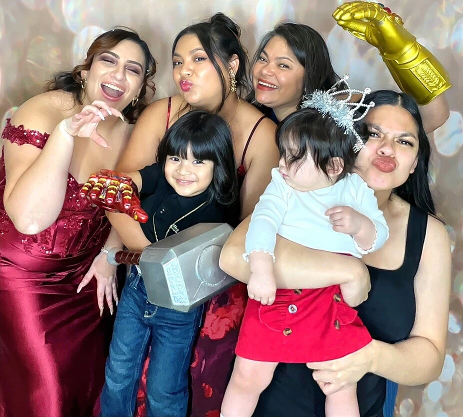 A family poses at a birthday party.