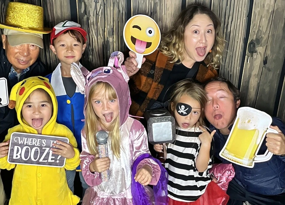 A group of guests poses in party costumes at a Halloween costume party.