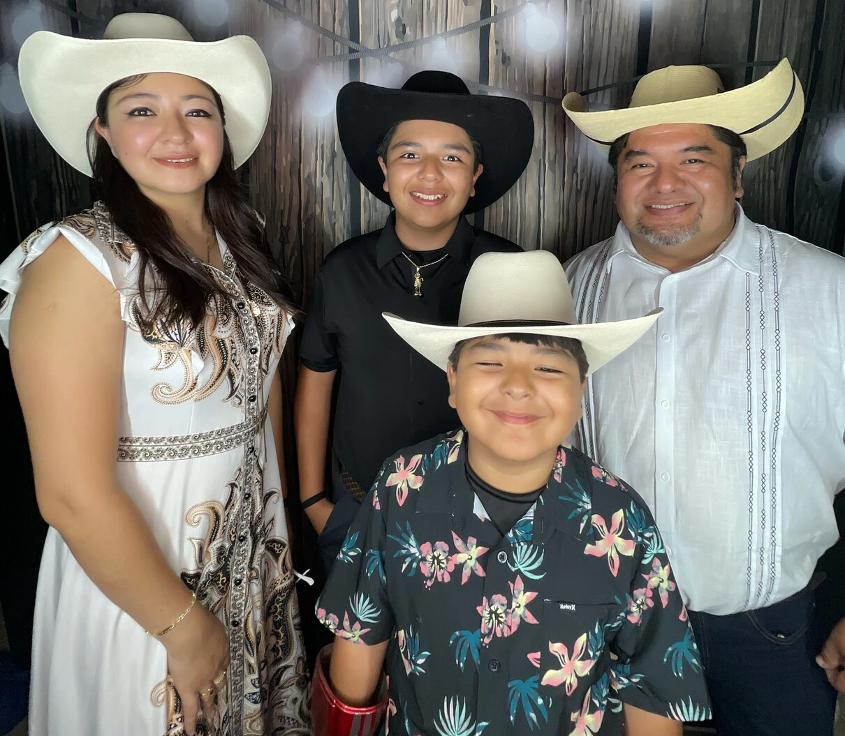 A family poses at a western-themed party.