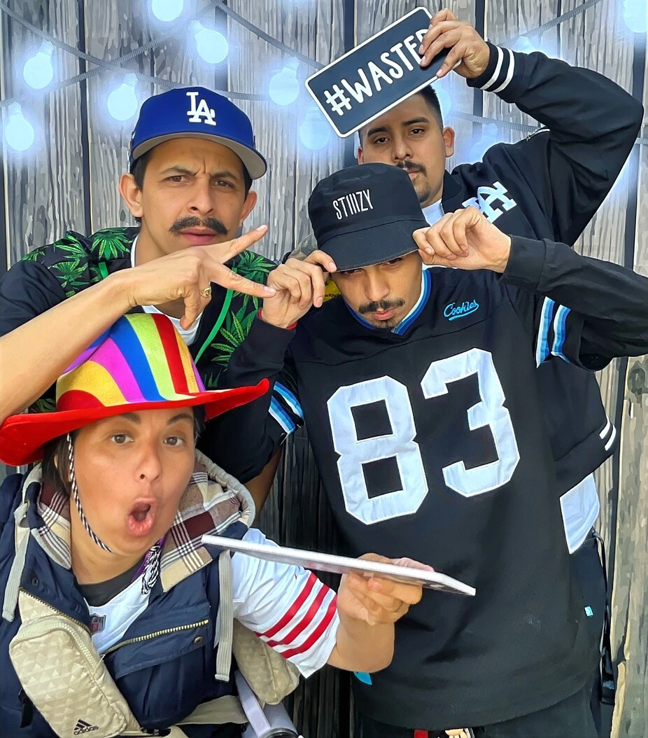 Guests pose with playful photo booth props at a Los Angeles celebration.