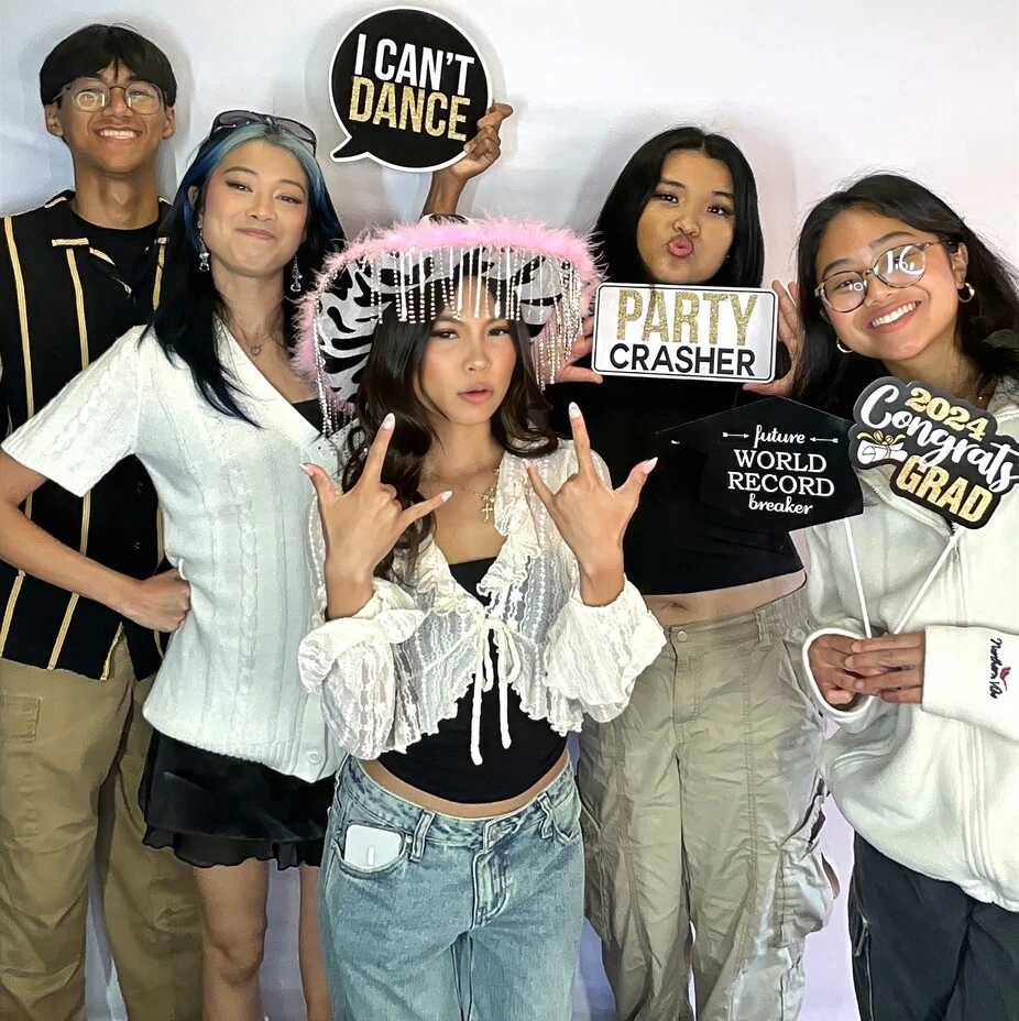 Party guests pose at a graduation celebration.