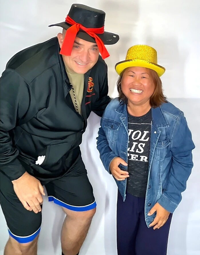 Guests pose with playful photo booth props at a graduation celebration.