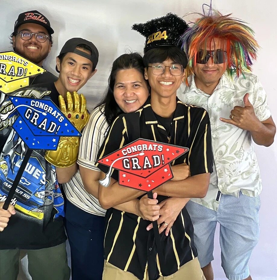 Friends pose at a graduation celebration.