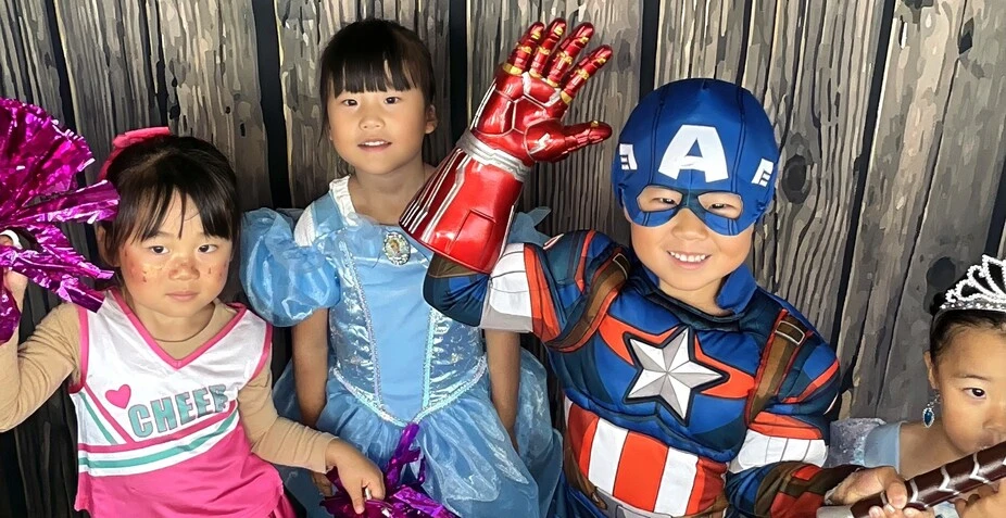 Guests pose in party costumes at a Halloween costume party.