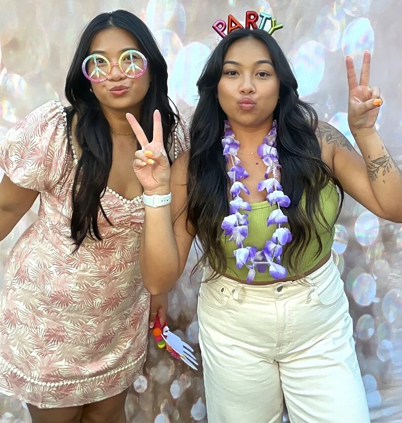 Guests pose at a tropical-themed party.