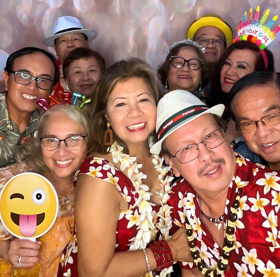A family poses at a tropical-themed party.