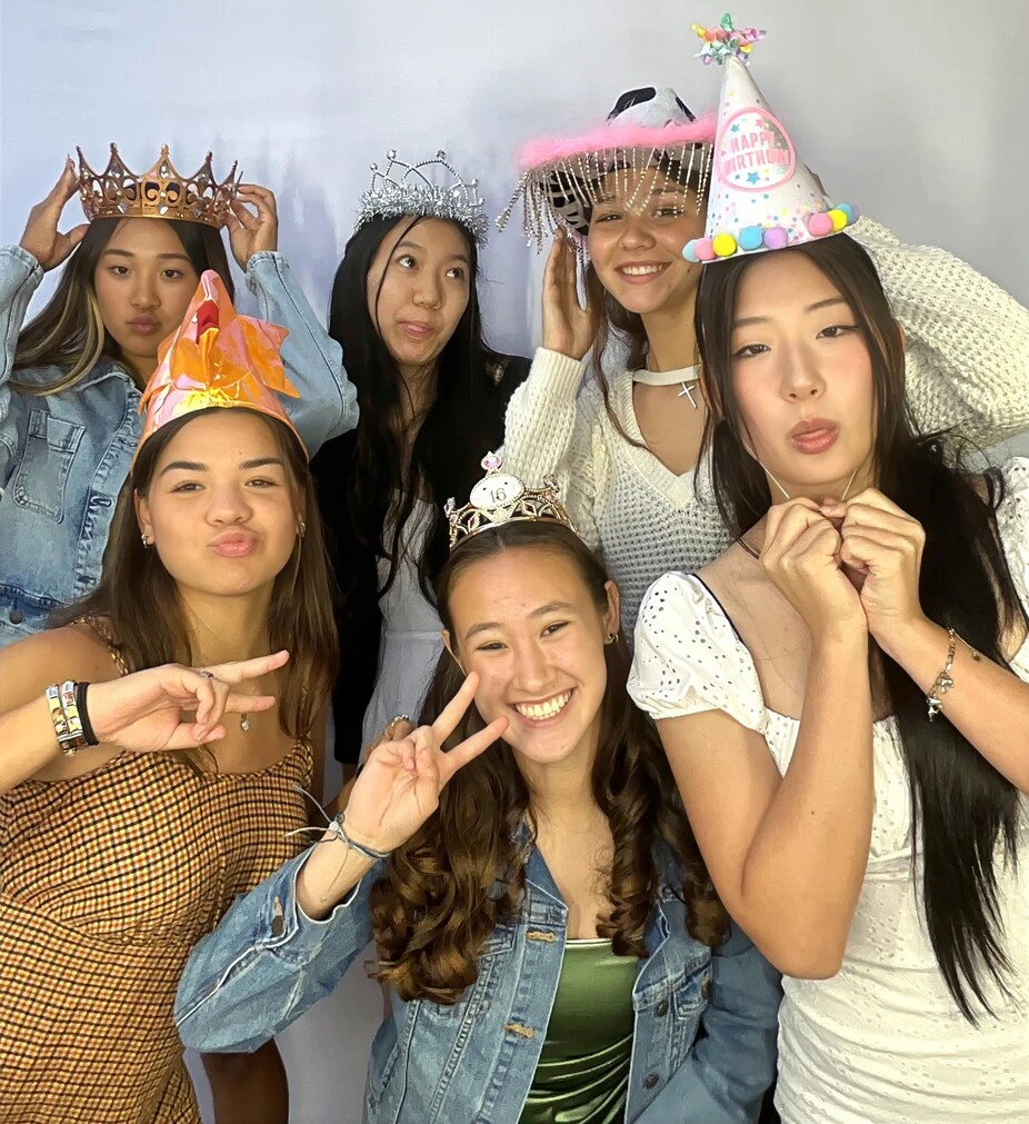 Teen friends pose at a birthday party.
